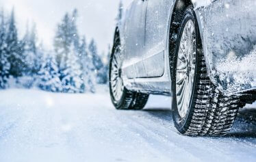 Snowy tires driving on a snowy road